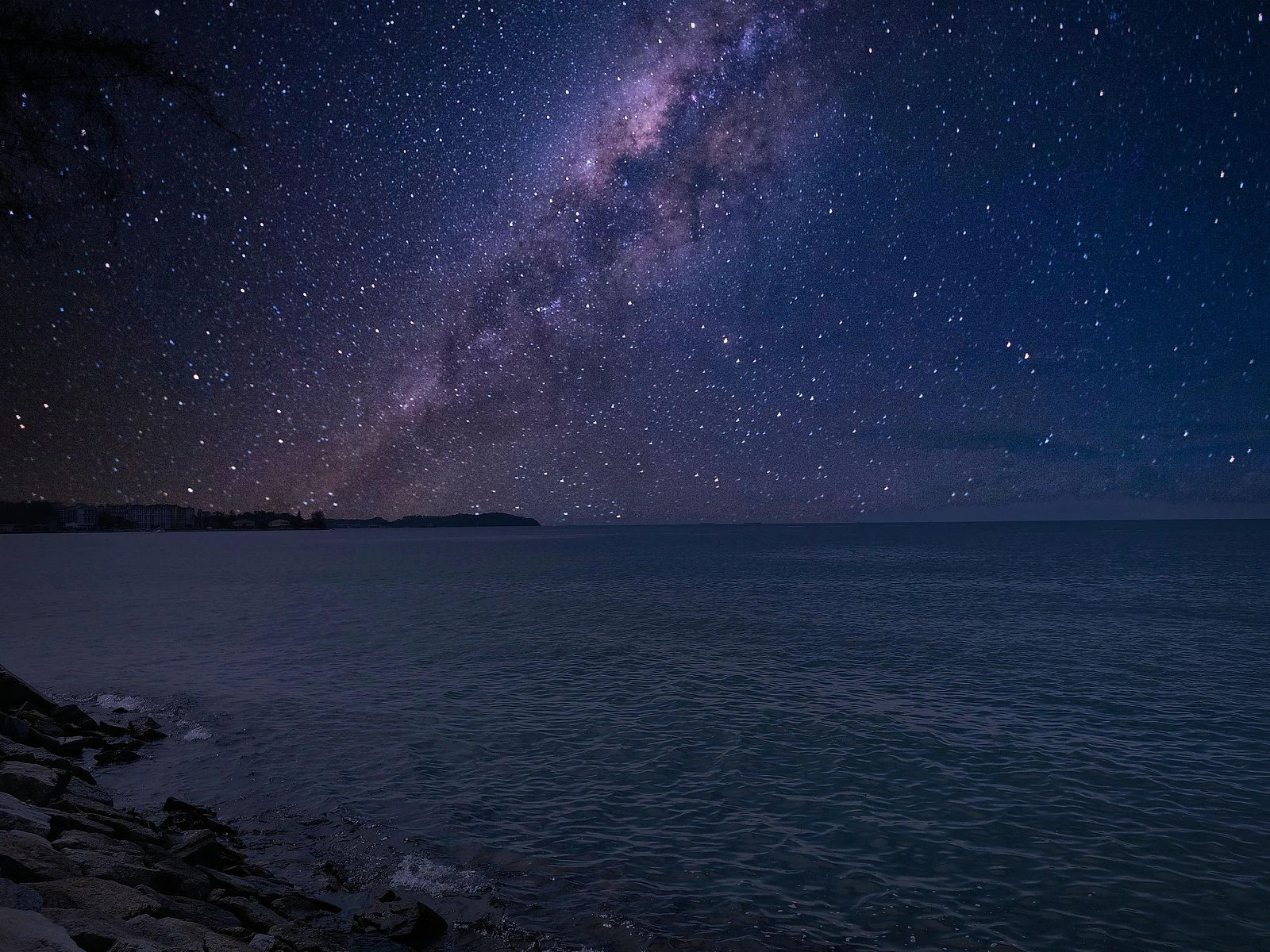 Starry night sky over the ocean, the setting for the bioluminescent plankton swim near Ao Nang